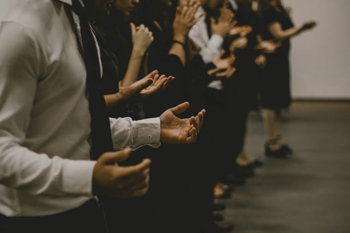 People worshipping together inside a room